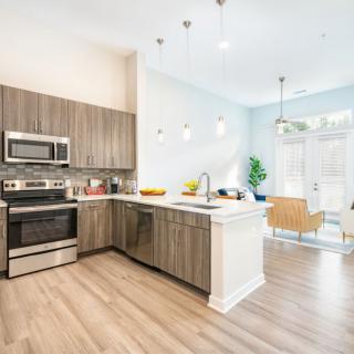 A modern kitchen with stainless steel appliances and sleek interior design.