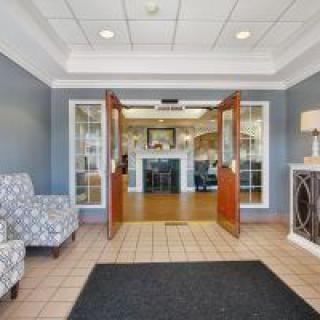 A welcoming lobby entrance with comfortable seating and open doors.
