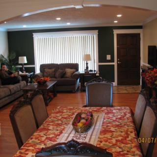 A cozy living room and dining area with warm decor and comfortable seating.
