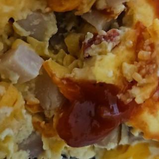 An omelette topped with cheese and sauce.