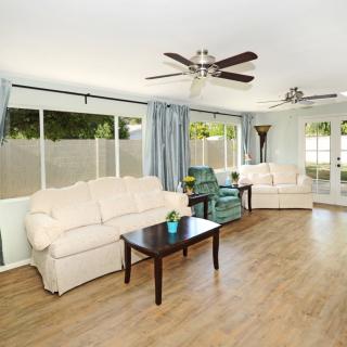 Spacious living room with comfortable seating, large windows, and modern decor.