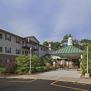 A residential building with a covered entrance and landscaping.