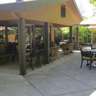 An inviting restaurant patio with outdoor seating under a sunny sky.