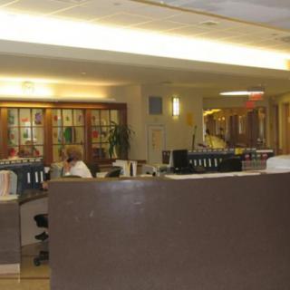 An office interior with desks and computer workstations.