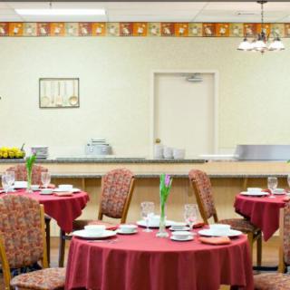 A cozy restaurant dining room with tables set for guests.