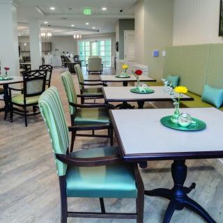A neatly arranged dining area with tables and chairs.