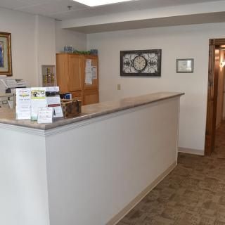 A reception desk area with a counter and office decor.