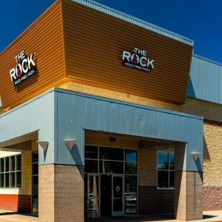 The exterior of a restaurant building with prominent signage.