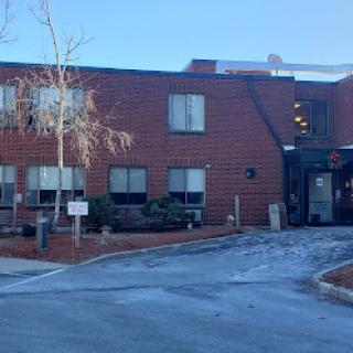 A brick building with a clear sky in the background, indicating winter weather.