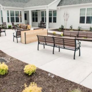 A well-maintained outdoor patio area with benches and landscaping.