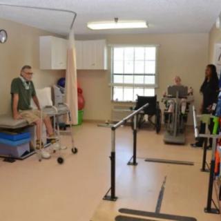 A rehabilitation clinic with patients engaging in physical therapy exercises.
