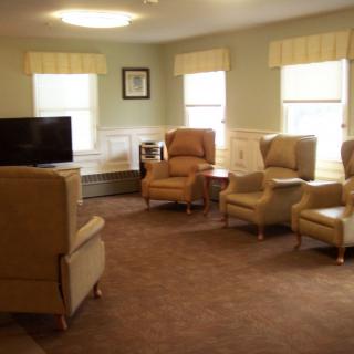 Cozy living room with comfortable chairs and a television.