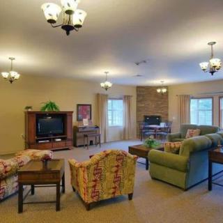 A cozy living room with comfortable seating and a television.