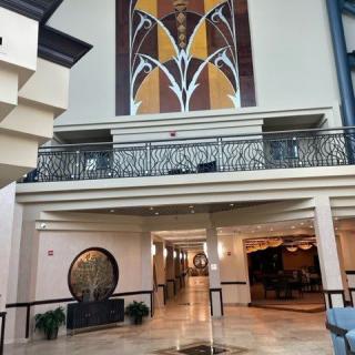 Modern hotel lobby with art deco elements and striking artwork.