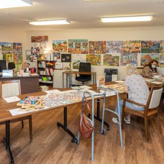A cozy art studio filled with various magazines and a workspace for creativity.