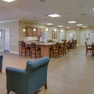 A spacious modern kitchen and dining area with wooden furniture.