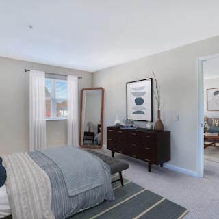 A beautifully designed modern bedroom capturing natural light with stylish furniture and decor.