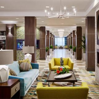 A modern hotel lobby with colorful seating and elegant decor.