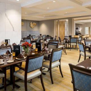 An elegant restaurant dining area with neatly arranged tables and chairs.