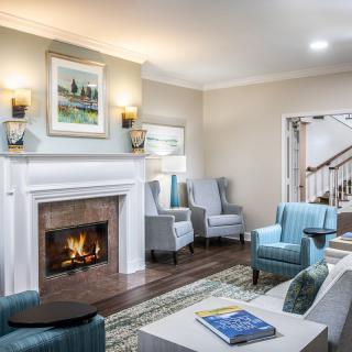 A cozy living room with a fireplace, modern furniture, and elegant decor.