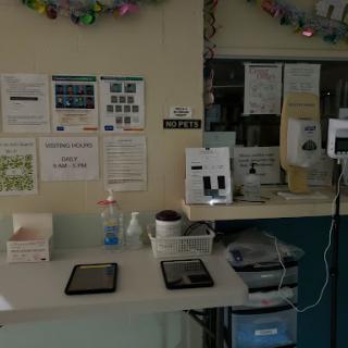 A healthcare workstation with tablets, medical supplies, and informational posters.