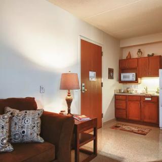 A cozy apartment with a small living area and kitchenette.