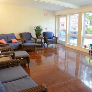 A cozy waiting area with comfortable seating and large windows letting in natural light.