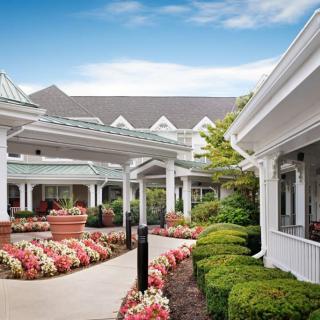Beautifully landscaped garden path with a scenic view of elegant buildings.