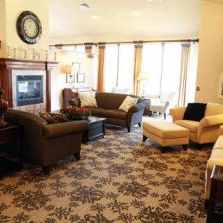 A cozy living room with comfortable seating, a fireplace, and elegant decor.