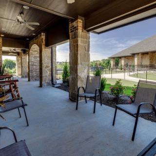 A modern patio with outdoor seating and a scenic landscape view.