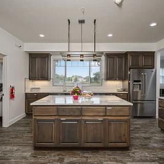 A modern kitchen with a central island and stainless steel appliances.