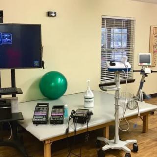 A physical therapy room equipped with rehabilitation devices and tools.