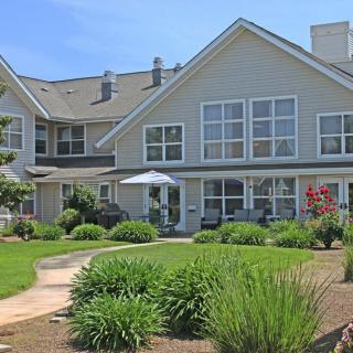 A large residential house with a well-maintained garden and pathway.