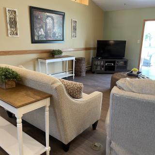 A cozy living room featuring comfortable seating, a television, and decorative elements.