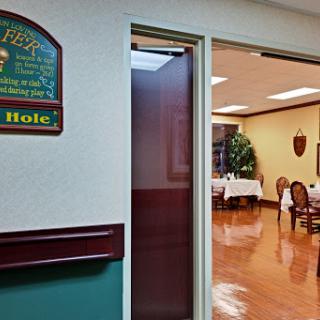 A glimpse into a dining area, revealing well-set tables and a welcoming ambiance.