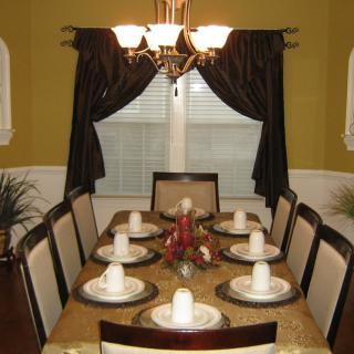 A well-set dining table with a decorative centerpiece and elegant lighting.