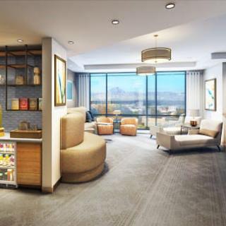 A modern living room with ample natural light and city views.