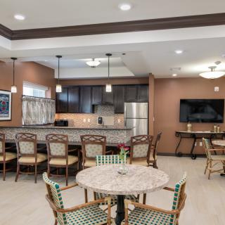 A modern kitchen and dining area with stylish furniture and contemporary lighting.