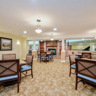 A cozy lounge area with seating, a fireplace, and elegant decor.