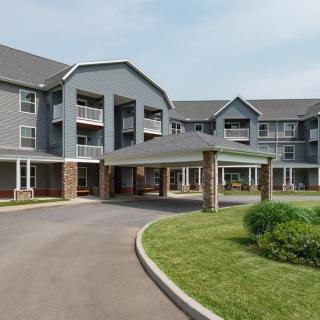 A modern residential apartment complex with an inviting entrance and landscaped surroundings.