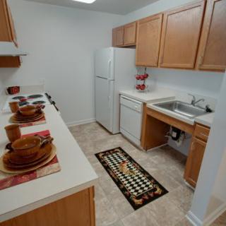 A compact kitchen with wooden cabinets and modern appliances.