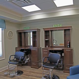 A hair salon interior with chairs and mirrors.