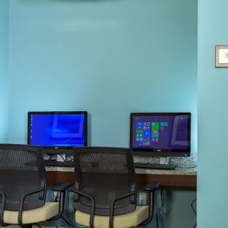 A small office space with two computer workstations and chairs.