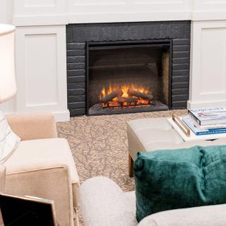 A cozy living room with a fireplace and comfortable seating.