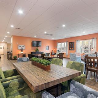 A modern and inviting community dining area with comfortable seating and stylish decor.