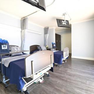 A hospital room featuring medical beds and equipment.