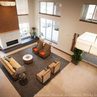 A modern living room with ample seating and large windows.