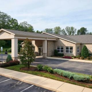 A small healthcare clinic with a landscaped entrance and parking lot.