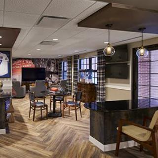 A modern and cozy lounge area with stylish furniture and warm lighting.