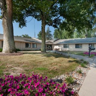 A serene residential area featuring blooming flowers and well-maintained trees.